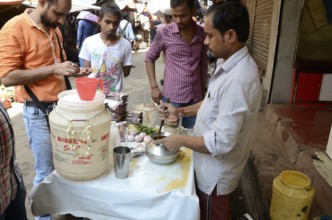 Man churning lassi, Kolkata, West Bengal, India, Asia