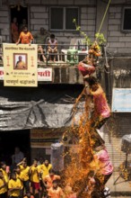 Men human pyramid breaking Dahi Handi, Janmashtami festival, Mumbai, Maharashtra, India, Asia