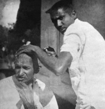 Mahatma Gandhi getting shaved during the salt march, March 1930 - MODEL RELEASE NOT AVAILABLE