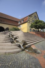 Market square and fountain with water features and half-timbered house Alter Posthof, Hattersheim,