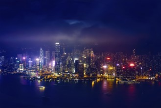 Aerial view of illuminated Hong Kong skyline cityscape downtown skyscrapers over Victoria Harbour