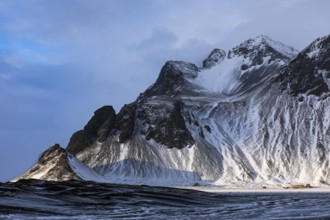 Snowy rocky slopes of Klifandur, near Höfn, Sudausturland, Iceland, Europe