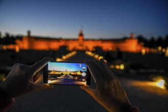 Karlsruhe castle at dusk in the display of a mobile phone, Karlsruhe, Baden-Württemberg, Germany,