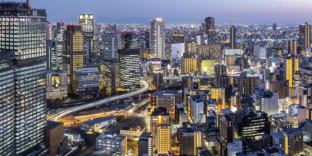 Osaka city from above with the skyline skyscrapers panorama at night in Osaka, Japan, Asia