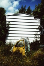 Abandoned car wreck in nature. Puy de Dome department. Auvergne-Rhone-Alpes. France