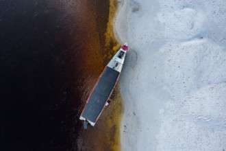 Boat anchoring at a white sand beach, Cerros de Mavecure, Eastern Colombia