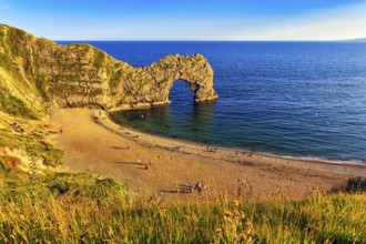 Coastline with bathing beach at Durdle Door, limestone rock bridge, UNESCO World Heritage Site,