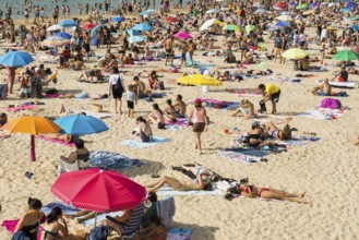 Crowded beach with people in August, San Sebastian, Donostia, Basque Country, Northern Spain,