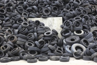 Old car tyres lie on stockpiles for recycling