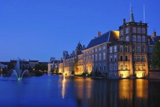 View of the Binnenhof House of Parliament and the Hofvijver lake with downtown skyscrapers in