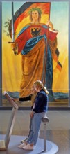 Two woman at a screen in front of the painting of Germania by Philipp Veit, Haus der Geschichte,