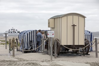 Civil wedding in a bathing cart on the west beach with the passing ferry Frisia, Norderney Island,