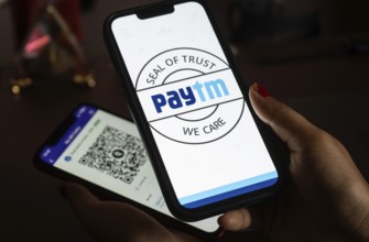 In this photo illustration, the Paytm logo and PhonePe QR code, is seen displayed on mobile phones