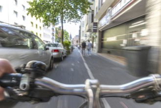 Cycling from a first-person perspective on a cycle path in Cologne, North Rhine-Westphalia,