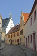 Houses in Kreuzgasse and gable with spire from the Romanesque Cathedral of St. Mary, Freiberg,