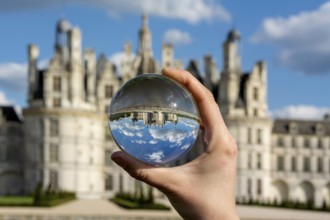 View of the Chateau de Chambord through a transparent ball. Loir-et-Cher department, Centre-Val de