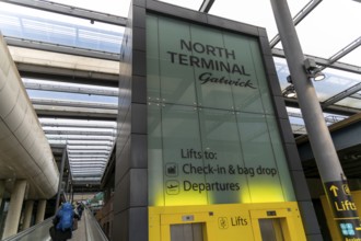 Sign for lifts and walkway at North Terminal, London Gatwick airport, England, UK