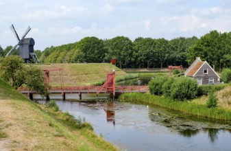 Bourtange Fortress, drawbridge over fortress moat, trestle windmill, Groningen Province,