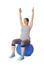 Pregnancy exercise concept, pregnant woman doing exercises with exercise ball isolated on white