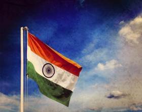 Vintage retro effect filtered hipster style image of India indian flag against blue sky with