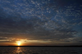 Sunrise with cloud formation over a lake in Mecklenburg, Müritz National Park,