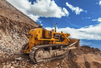 LADAKH, INDIA, SEPTEMBER 12, 2011: Bulldozer doing road constractuion on Kardung La pass in