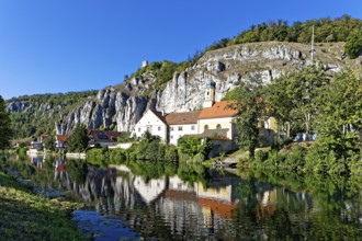 Side arm of the Altmühl, houses, Holy Spirit Parish Church, reflection in the water, on top of rock