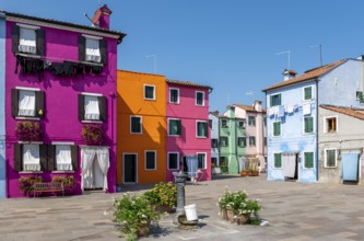 Colourful houses with washing lines and flowers, colourful house facades, alleyways on the island