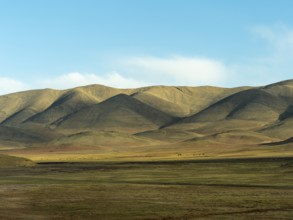 Mountain landscape and vast plain in the highlands of Tibet, China, Asia