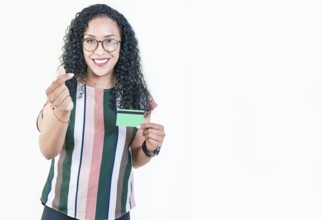 Happy afro girl in glasses holding credit card making money gesture with fingers, looking at camera