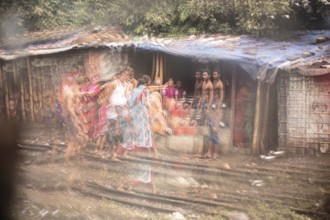 Family in front of their dwelling in the reflection of a broken mirror, Tejgaon Slum Area, Dhaka,