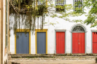 Facade of colorful houses in colonial style on the streets of the city of Paraty on the coast of