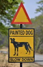 Warning Sign Painted dog, Attention African Wild Dogs, Hwange National Park, near Hwange,