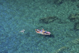 Bathers in the rocky bay of Corniglia, Cinque Terre, province of La Spezia, Liguria, Italy, Europe