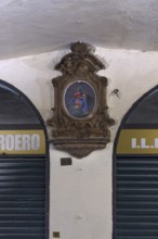 Marian picture with decorative frame in the old arcades at the harbour, Genoa, Italy, Europe