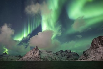 Northern Lights (Aurora Borealis) over mountains in winter, Olstinden, Hamnøy, Reine, Moskenesøy,