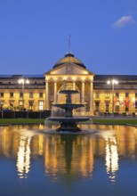 Illuminated spa hotel and Casino in the evening with cascade fountain, Wiesbaden, Hesse, Germany,