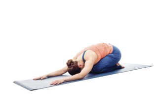 Woman doing Ashtanga Vinyasa Yoga relaxation asana Balasana, child posture, resting pose or counter