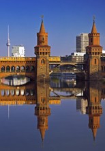 Oberbaum Bridge over the Spree with yellow underground and television tower,