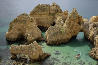 Excursion boats on the rocky coast near Lagos, Algarve, Portugal, Europe