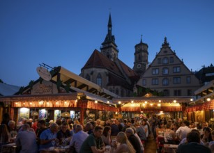 People sitting in wine arbours in the evening, Weindorf Stuttgart, Schillerplatz, collegiate