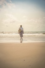 Woman on the beach in the evening sun, Zandvoort, Netherlands