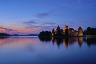 Night view of Trakai Island Castle in lake Galve illuminated in the evening, Lithuania, Europe