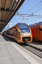 Railway passenger trains of the type Stadler Flirt of the Südostbahn at Arth-Goldau station,