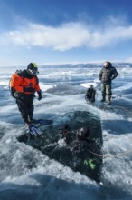 Scuba divers ready for an ice dive, Lake Baikal, Pribaikalsky National Park, Irkutsk Province,