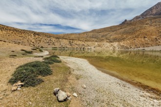 Himalayas mountains refelcting in mountain lake Dhankar Lake. Spiti Valley, Himachal Pradesh,