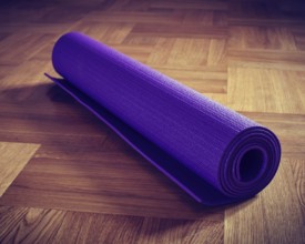 Vintage retro effect filtered hipster style image of Yoga mat on wooden floor