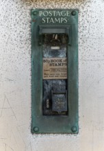 Old postage stamp coin machine no longer in use, UK