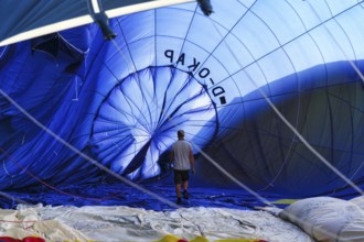 View into the interior of a blue hot air balloon, lying on the ground, preparation for the 26th