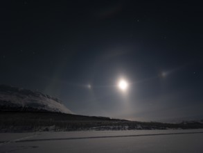 Northern Lights with Moon Halo, Moon-dogs, the Big Dipper and Polaris next to Saana, a sacred Sámi